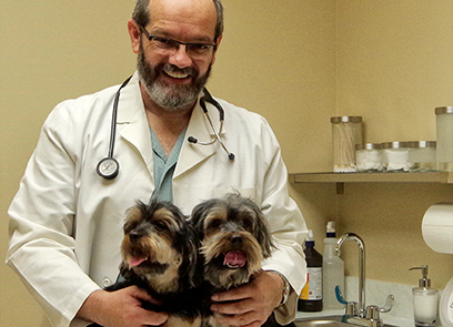 Dr. Z with his two pet Yorkshire terriers, Lua and Pinja.